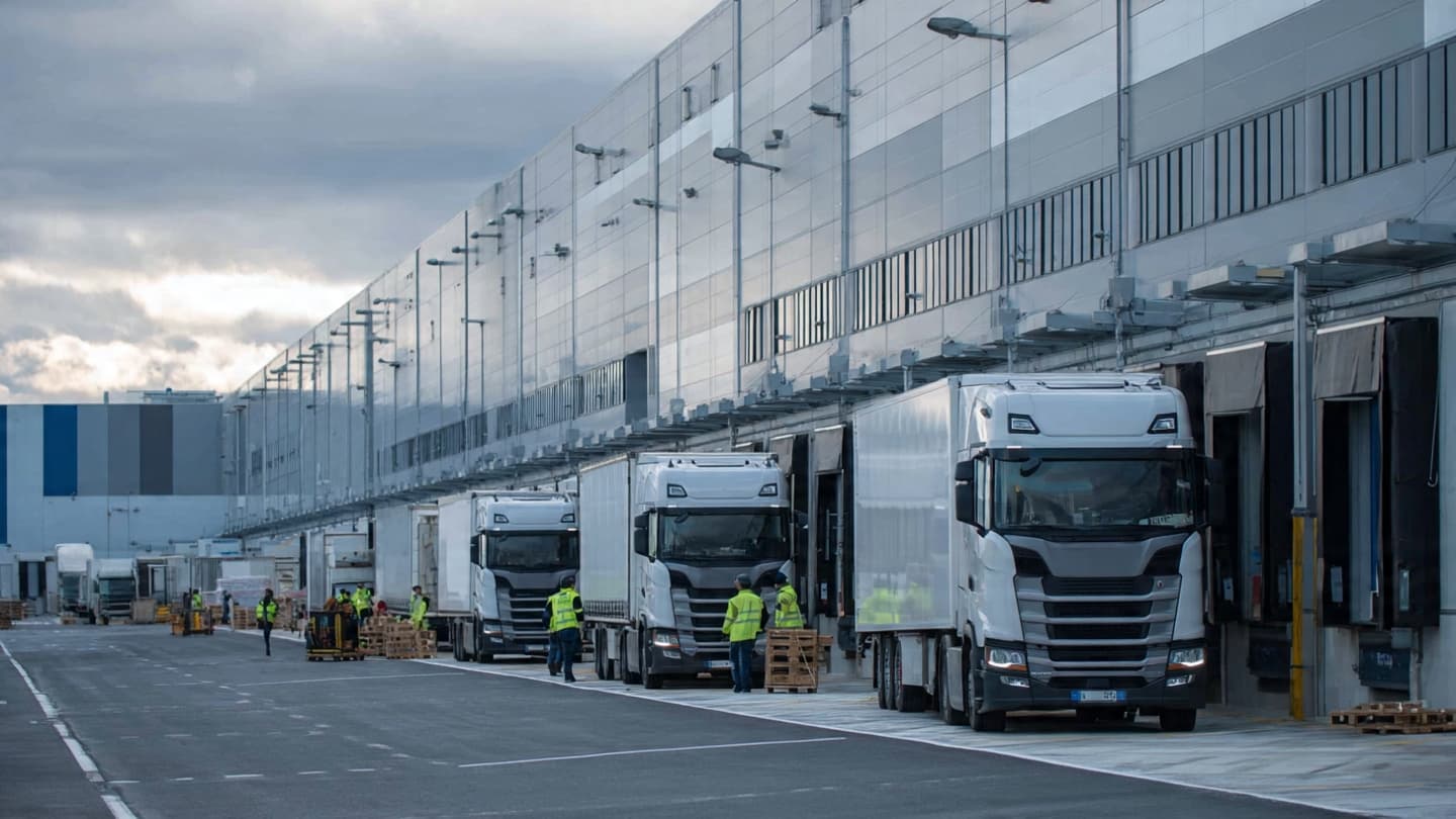 A Promise of Jobs Beneath the Steel of Warehouses