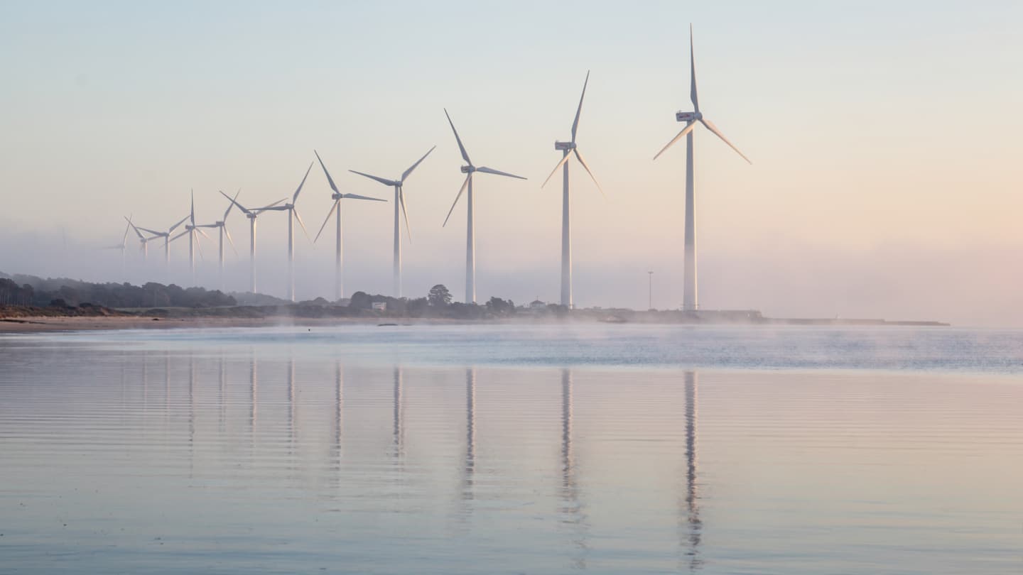 The Silent Harvest of the Wind: When the Great Blades Turn Under a Crimson Sun
