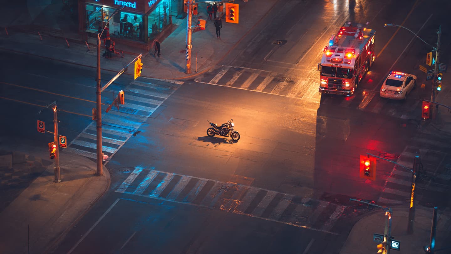 In the Quiet After the Sirens: A Suspended Motorcycle and the Fragility of Urban Motion